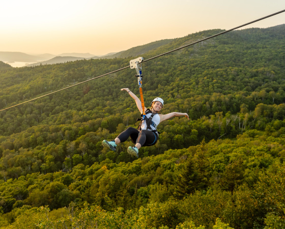 Zipline over Mont Tremblant forest at sunset